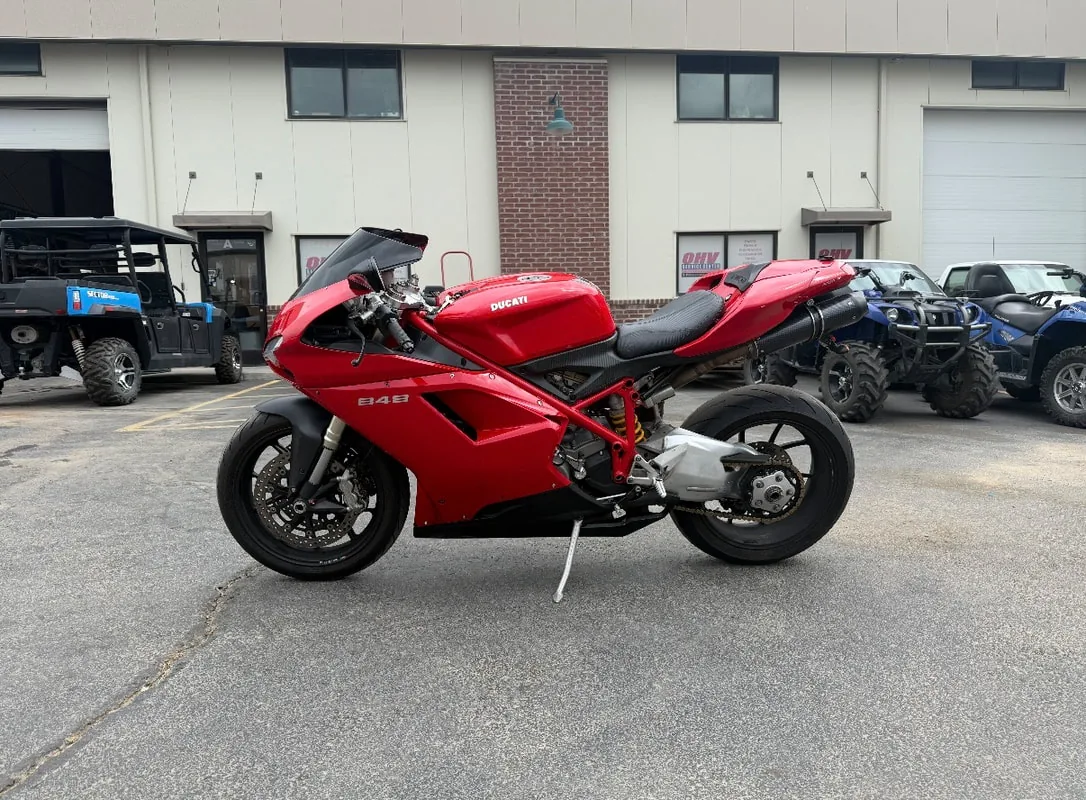 Red Ducati sportbike in the parking lot after repair