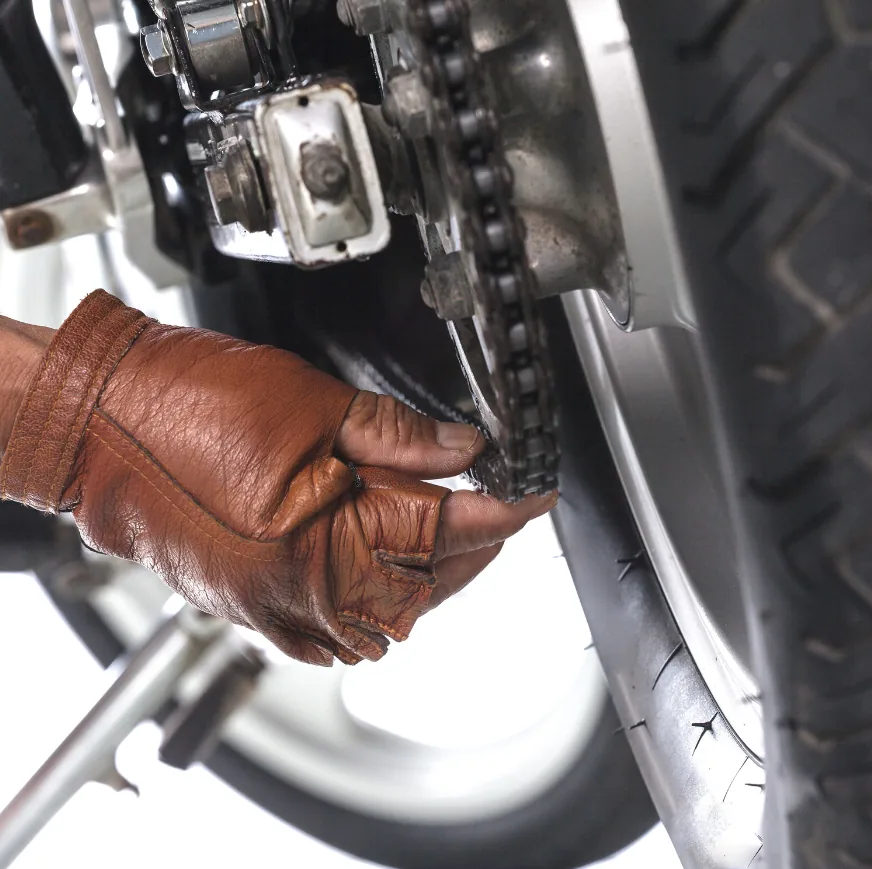 Mechanic adjusting a motorcycle drive chain